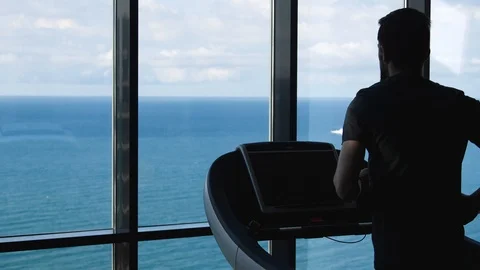 Run on the treadmill by the window overlooking the sea Stock-Footage 92418889