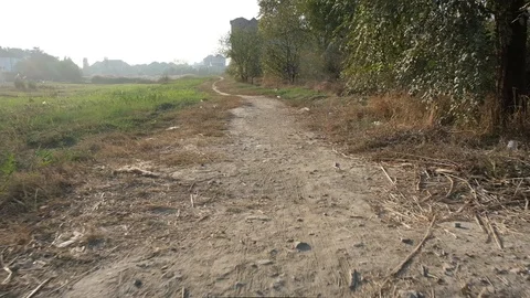 Run view on dust track from first person on sunny day.  Trash on road. Stock Footage 121048597