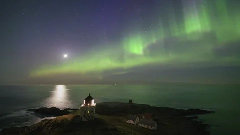 Runde lighthouse during a moonlit night with the aurora borealis Stock Footage 250427921
