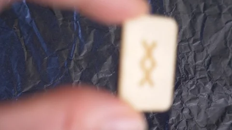 Rune. close-up, hand puts the rune on the surface for divination. 4k, slow Stock Footage 88059833