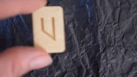 Rune. close-up, hand puts the rune on the surface for divination. 4k, slow Stock Footage 88060075