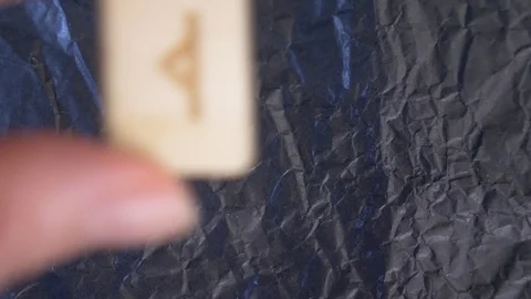 Rune. close-up, hand puts the rune on the surface for divination. 4k, slow Stock Footage 88060123