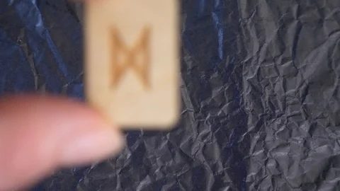 Rune. close-up, hand puts the rune on the surface for divination. 4k, slow Stock Footage 88060358