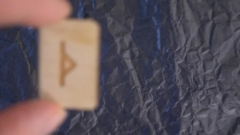 Rune. close-up, hand puts the rune on the surface for divination. 4k, slow Stock Footage 88061069