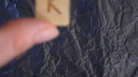 Rune. close-up, hand puts the rune on the surface for divination. 4k, slow Stock Footage 88061098