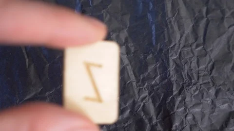 Rune. close-up, hand puts the rune on the surface for divination. 4k, slow Stock Footage 88061234