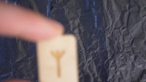 Rune. close-up, hand puts the rune on the surface for divination. 4k, slow Stock Footage 88061276