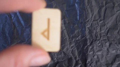 Rune. close-up, hand puts the rune on the surface for divination. 4k, slow Stock Footage 88061437