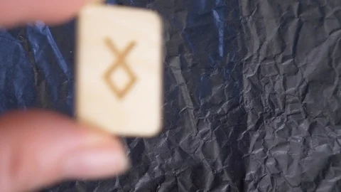 Rune. close-up, hand puts the rune on the surface for divination. 4k, slow Stock Footage 88061541