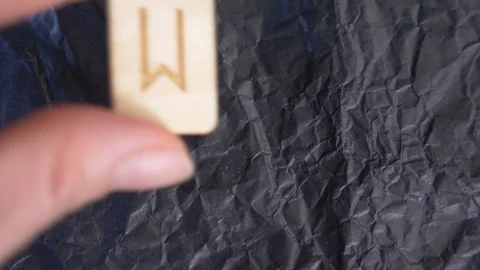 Rune. close-up, hand puts the rune on the surface for divination. 4k, slow Stock Footage 88061573