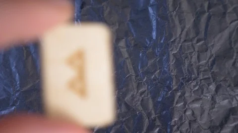 Rune. close-up, hand puts the rune on the surface for divination. 4k, slow Stock Footage 88061646
