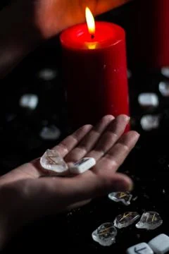 Runes in the hand of the witch Stock Photos