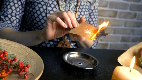 Runic magic. master burns runic spell on parchment Foto stock