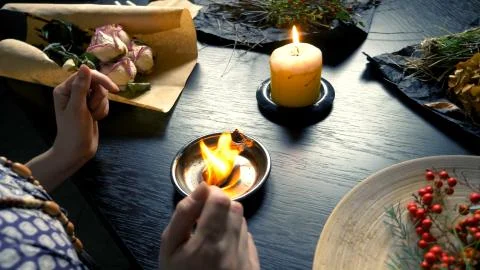 Runic magic. master burns runic spell on parchment Stock Photos