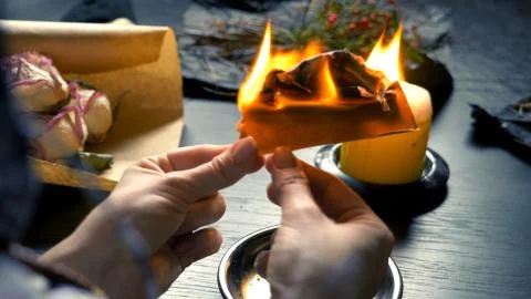 Runic magic. master burns runic spell on parchment Foto stock