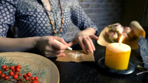 Runic magic. master writes runic spell on parchment 스톡 사진