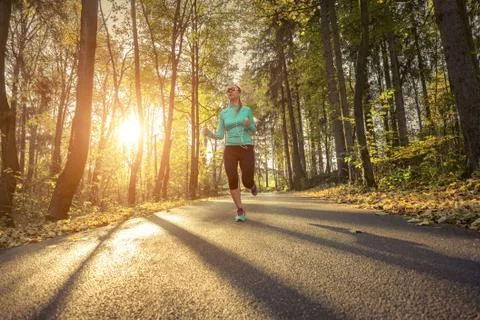 Runner in action at autumn. Stock Photos