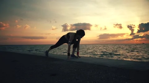 Runner athlete doing exersises at seaside Stock-Footage 67600283