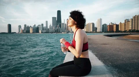 Runner athlete drinks water and smiling at seaside Video stock 67600861