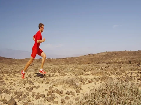Runner athlete man running on trail in desert Stock Footage 75058067