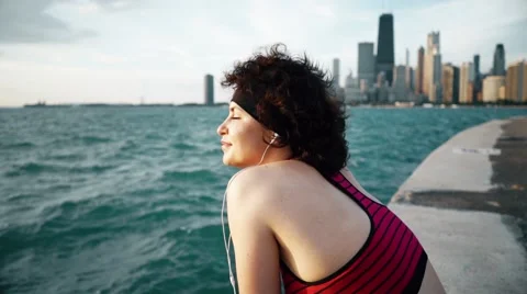 Runner athlete sitting and smiling at seaside Stock-Footage 67601071