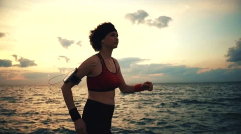 Runner athlete start running at seaside with skyscrapers on the background Stock-Footage 67619875