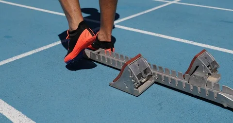 Runner athlete starting running at start of run on athletics running track Stock Footage 124669704