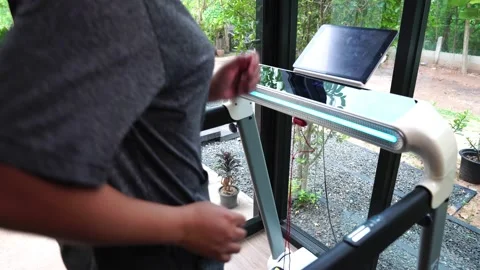 Runner athletic running on treadmill in home gym Stock Footage 194384445