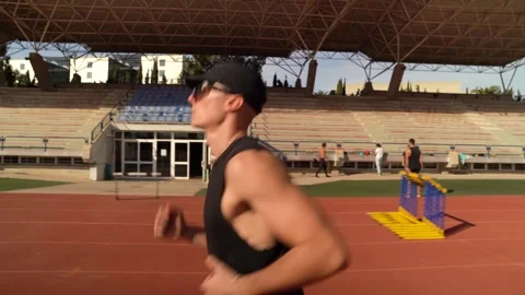 Runner on athletics track running. Side tracking of young boy athlete. Trai.. Stock Footage 267894498