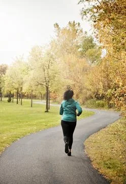 Runner, back of woman and path with fitness, outdoor and exercise routine w.. Stock Photos