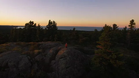 A runner on a bluff during sun set in Northern Michigan Stock Footage 136679275