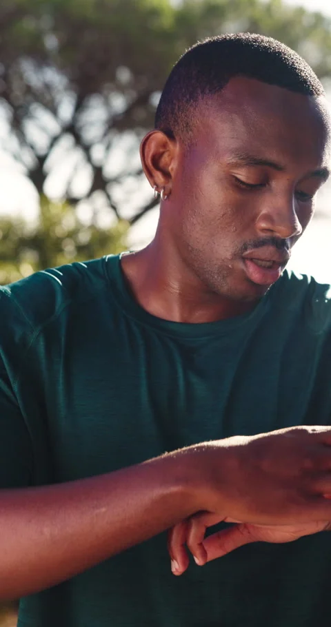Runner, breathing and smart watch with black man in nature for tracking heart Stock Footage 337453703
