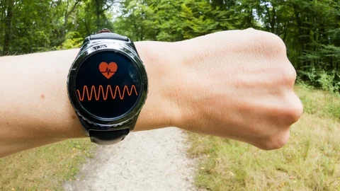 A runner checking his pulse on a smartwatch Video stock 104377969