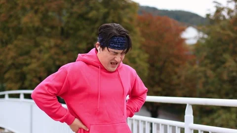 Runner in colored clothes crosses bridge in morning.athlete is tired of running 스톡 동영상 253826548