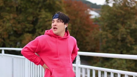 Runner in colored clothes crosses bridge in morning.athlete is tired of running 스톡 동영상 259489787
