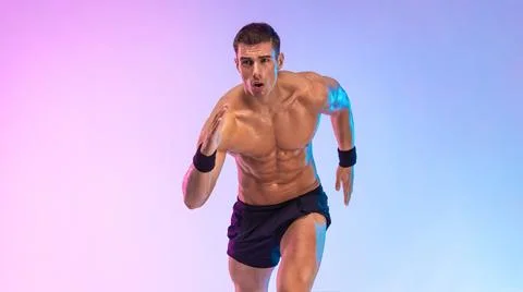 Runner concept. Athlete sprinter running on pink background. Fitness and sport Stock Photos