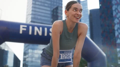 Runner Crossing Finish Line in Marathon Stock Footage 251667708