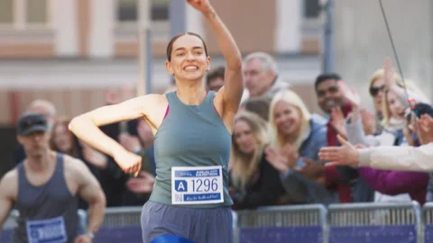 Runner Crossing Finish Line in Marathon Stock Footage 251668664