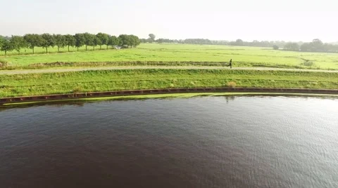 Runner on dike along river. Typical Dutch landscape. 스톡 동영상 66377944