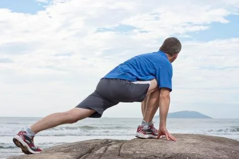 Runner doing stretching exercise Stock Photos