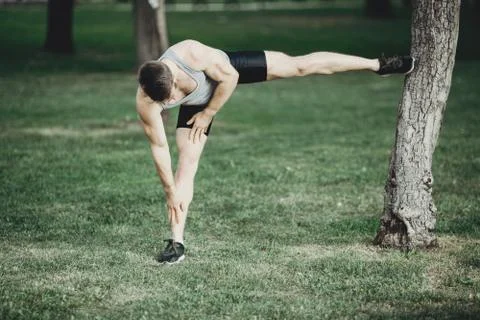 Runner doing stretching exercise before workout Stock Photos