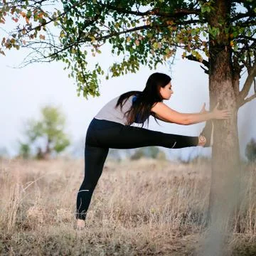 Runner doing stretching exercise before workout Stock Photos