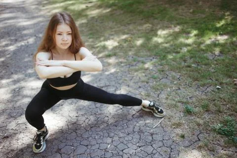 Runner doing stretching exercise before workout Stock Photos