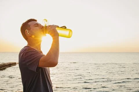Runner drinking water from the bottle after the jogging Stock Photos