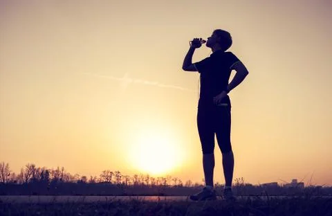 Runner drinks water after training Stock Photos