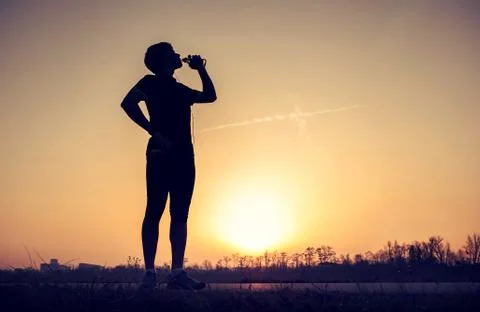 Runner drinks water after training Stock Photos