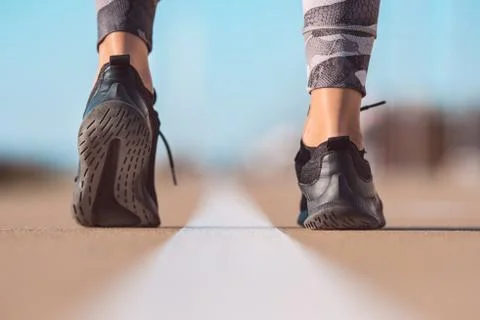 Runner feet preparing to run. Closeup on shoe. Woman exercising outdoors Stock Photos