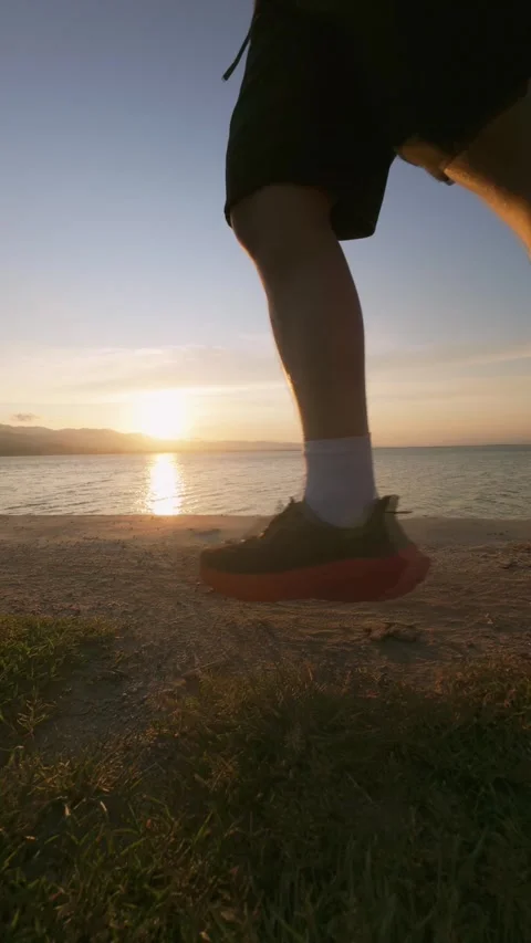 Runner feet running on lake at sunset Stock Footage 300008045