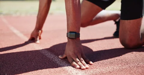 Runner, hands and shoes at start line on track with smart watch, race or launch Stock Footage 301385453