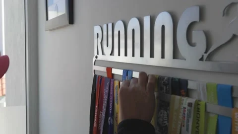 Runner hanging a medal Stock Footage 146987366